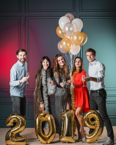 people-standing-with-2019-inscription-from-gold-balloons people-standing-with-2019-inscription-from-gold-balloons